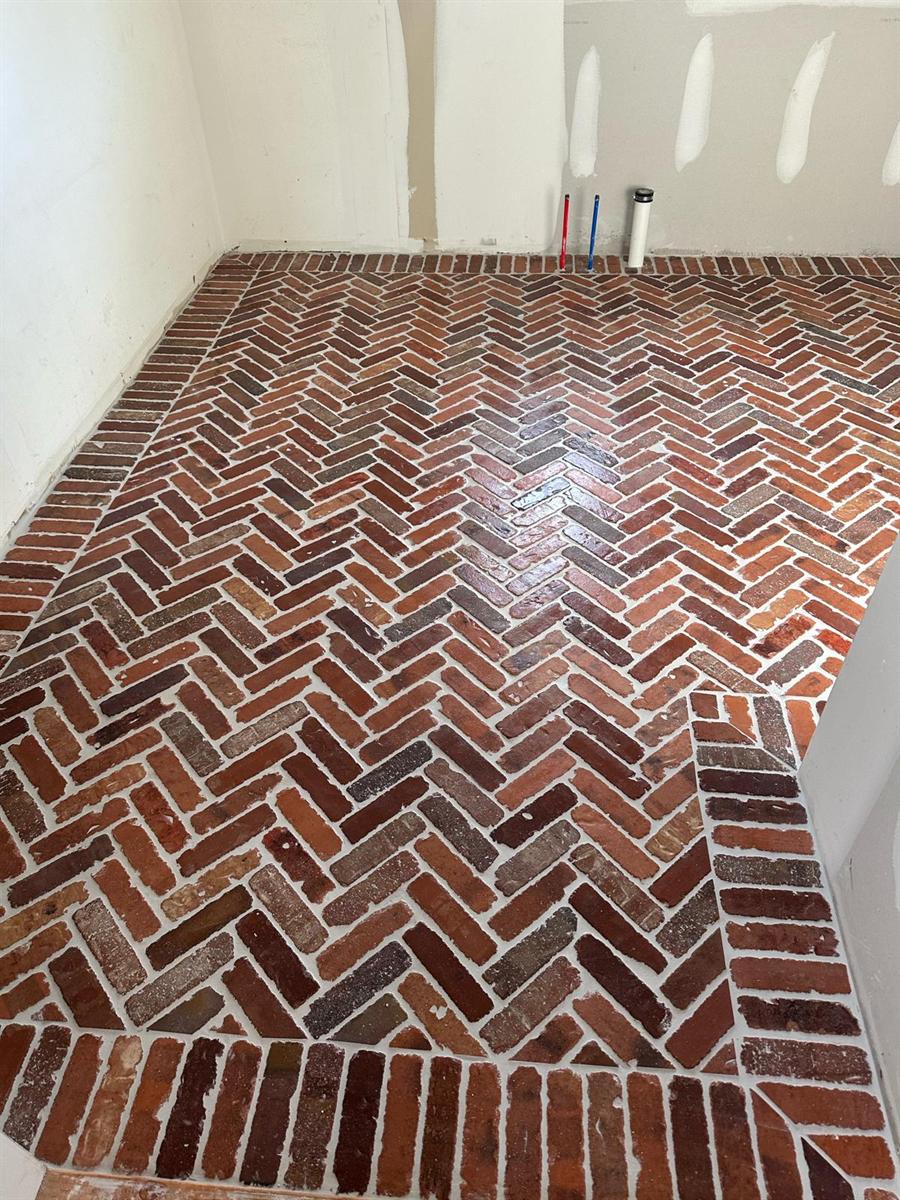 Red brick herringbone floor installed by Silcam Tile Installation in a New Jersey home