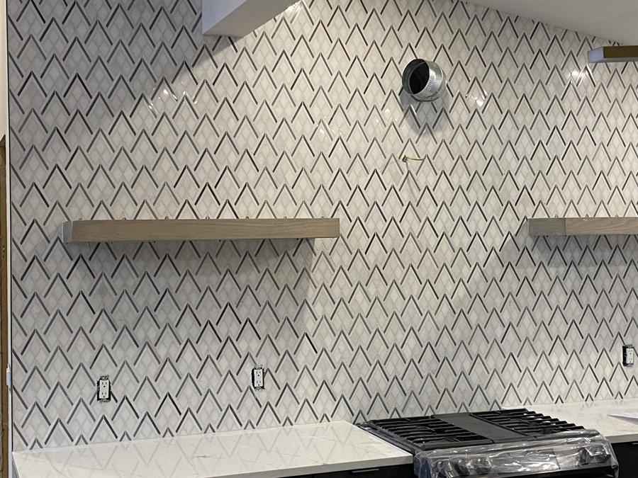 Herringbone marble backsplash with floating shelves, New Jersey