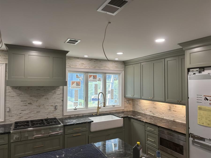 Sage green kitchen with marble slab backsplash, New Jersey