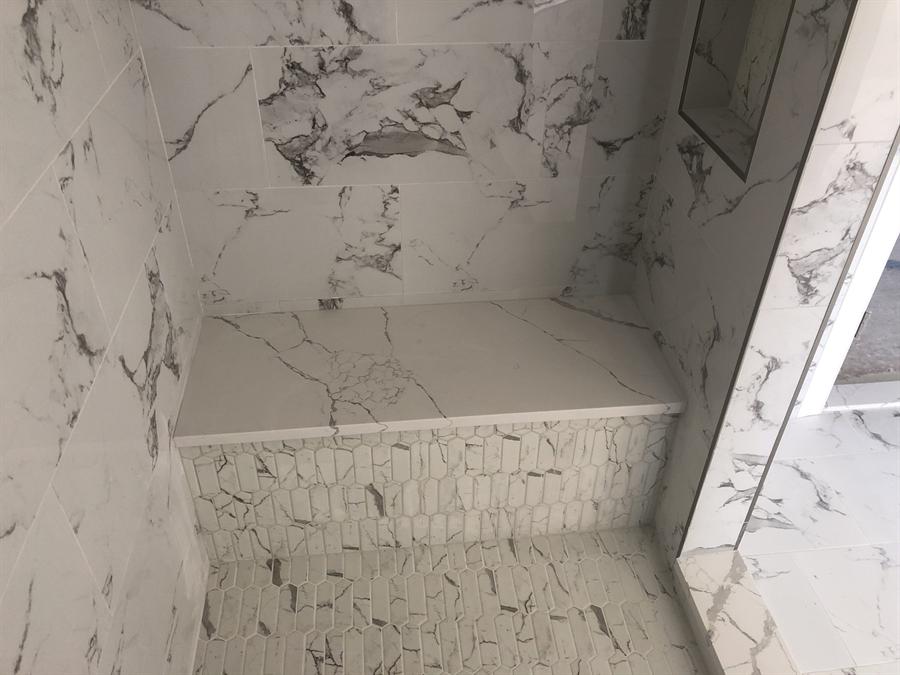 Marble shower with built-in bench and mosaic floor, New Jersey