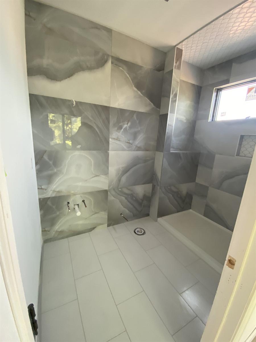 Marble shower walls with penny-round mosaic floor, New Jersey