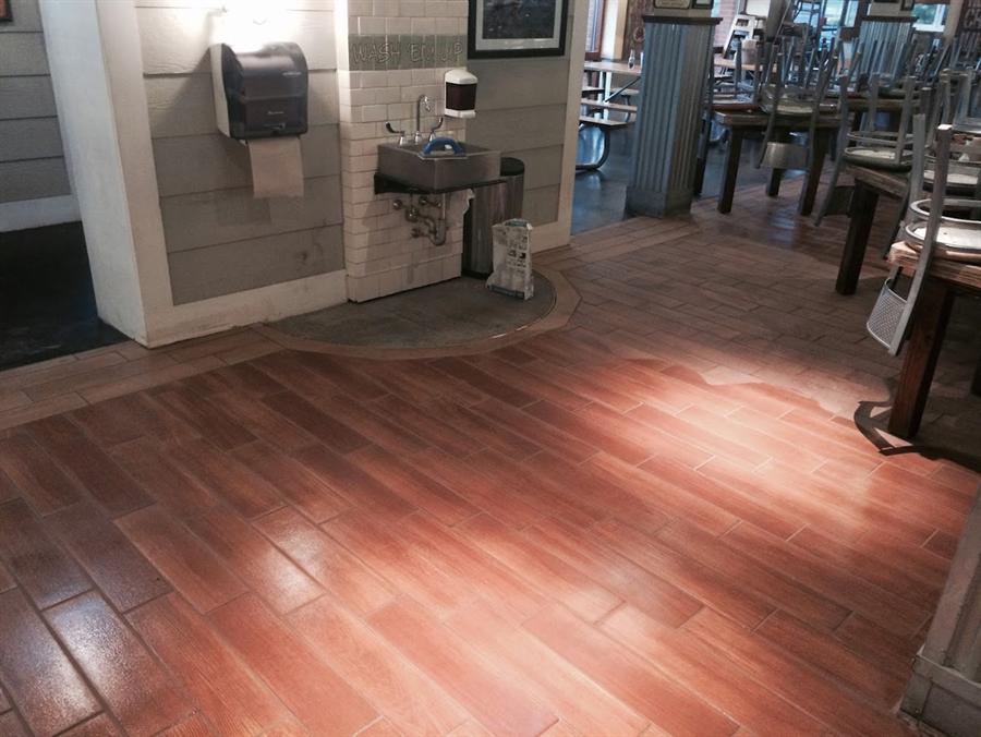 Hardwood floor meeting tile at a clean transition line, New Jersey