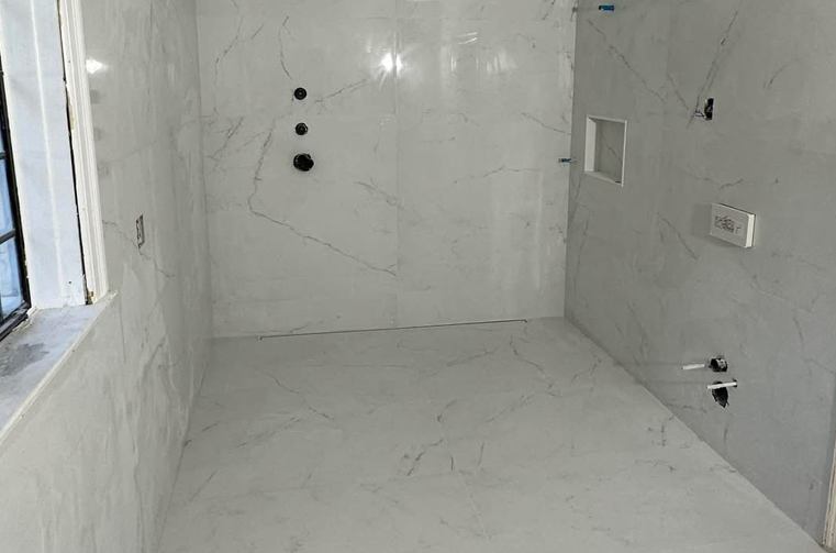 White marble walk-in shower with linear drain installed by Silcam Tile in New Jersey