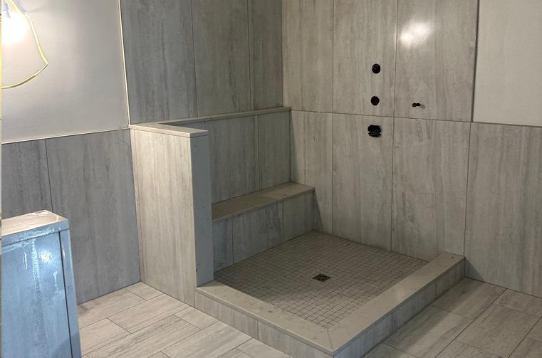 Finished tiled shower with built-in bench and step, fully waterproofed and installed by Silcam Tile in New Jersey