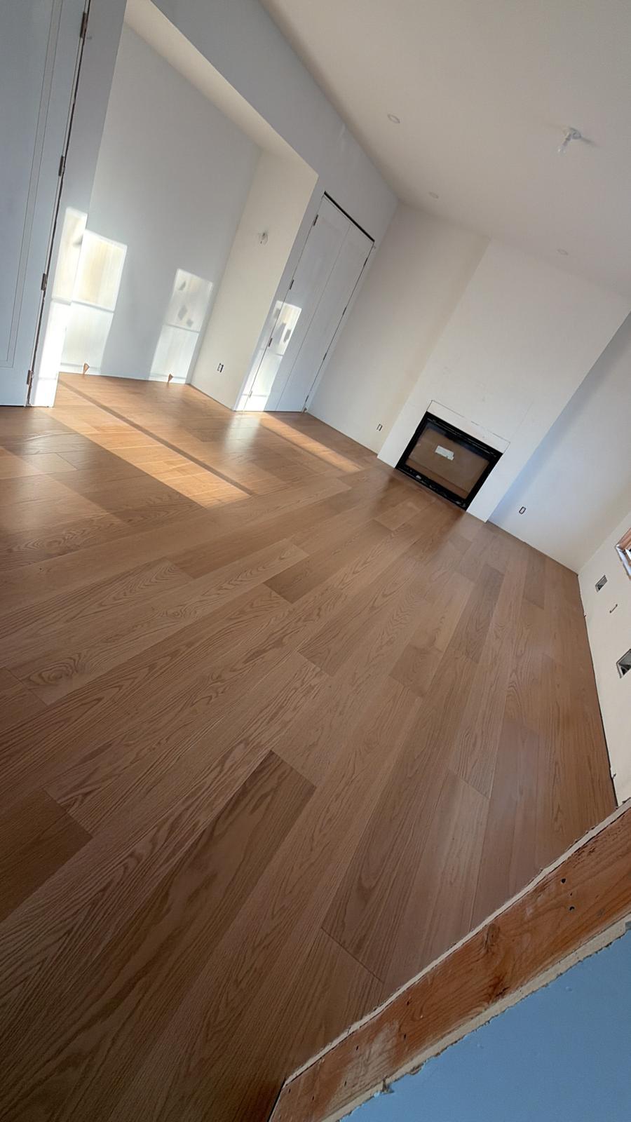 Wood-look flooring installed by Silcam Tile across a New Jersey living room